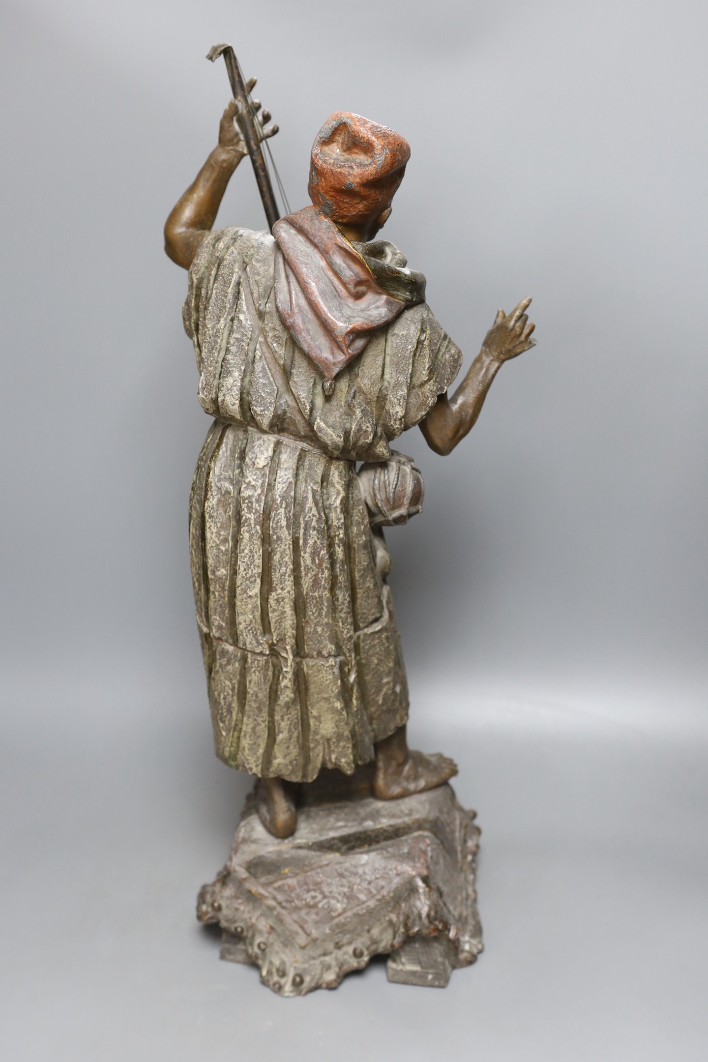 A late 19th French cold painted spelter model of an Arab playing a string instrument - 57.5cm tall